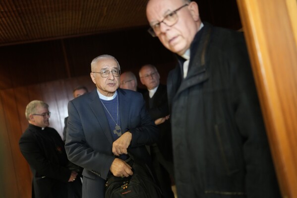 FILE - The head of the Portuguese Bishops Conference, Bishop Jose Ornelas, centre, arrives for a news conference to comment on the report released hours earlier by the Independent Committee for the Study of Child Abuse in the Catholic Church, set up by Portuguese bishops, in Lisbon, on Feb. 13, 2023. While the Catholic Church in the U.S., Australia and some other countries began coming to terms with their clergy sexual abuse legacies years ago and set up mechanisms to compensate victims, the hierarchy in Portugal has only recently offered an account and bungled its initial response to victims. (AP Photo/Armando Franca, File)