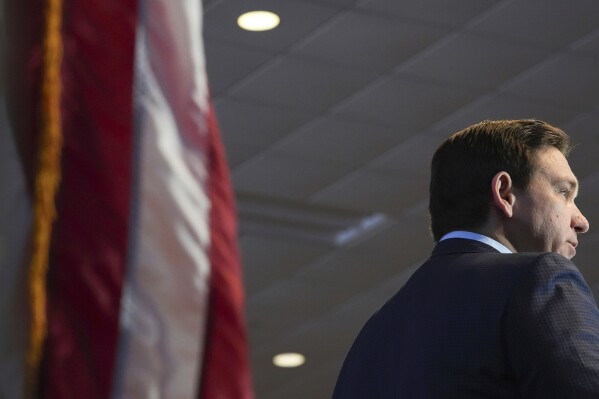 FILE - Florida Gov. Ron DeSantis speaks at a Contractors of America conference, Jan. 10, 2024, in Des Moines, Iowa. A Florida bill waiting to be signed by DeSantis would strip the term “climate change” from much of state law and reverse a policy then-Gov. Charlie Crist championed as he built a reputation for being a rare Republican fighting to promote green energy over fossil fuels. (AP Photo/Abbie Parr, File)