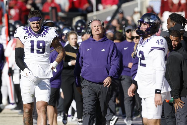 TCU head coach Sonny Dykes, center, looks at the scoreboard during the second half of an NCAA college football game against Oklahoma, Friday, Nov. 24, 2023, in Norman, Okla. (AP Photo/Alonzo Adams)