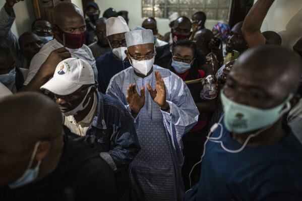 Guinean opposition leader Cellou Dalein Diallo, centre, walks with supporters at his headquarters in Conakry, Guinea, Monday Oct. 19, 2020. Diallo declared himself the winner after the country held an election on Sunday with Guinean President Alpha Conde seeking to extend his decade in power. (AP Photo/Sadak Souici)