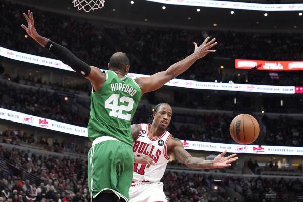 Chicago Bulls' DeMar DeRozan passes as Boston Celtics' Al Horford defends during the second half of an NBA basketball game Monday, Nov. 21, 2022, in Chicago. The Bulls won 121-107. (AP Photo/Charles Rex Arbogast)