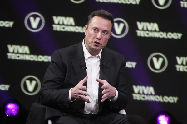 FILE - Elon Musk, who owns X, formerly known as Twitter, Tesla and SpaceX, speaks at the Vivatech fair, June 16, 2023, in Paris. Musk said Wednesday, Nov. 29, that advertisers who have halted spending on his social media platform X in response to antisemitic and other hateful material are engaging in “blackmail” and, using a profanity, essentially told them to go away. (AP Photo/Michel Euler, File)