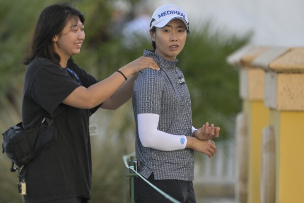 FILE - Narin An, right, gets a shoulder rub before teeing off on the first hole during the first round of the LPGA Drive On Championship golf tournament at Bradenton Country Club, Thursday, Jan. 25, 2024, in Bradenton, Fla. Sarah Schmeizel and Narin An were atop the leaderboard after two rounds of the Blue Bay LPGA on China's southern island of Hainan, both at 9-under and one shot clear of Hye-Jin Choi Friday, March 8, 2024. (AP Photo/Steve Nesius, File)