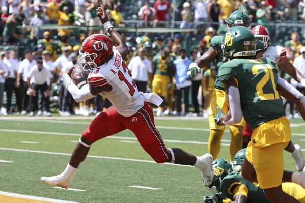Utah quarterback Nate Johnson (13) scores a touchdown against Baylor in the second half of an NCAA college football game, Saturday, Sept. 9, 2023, in Waco, Texas. (AP Photo/Jerry Larson)