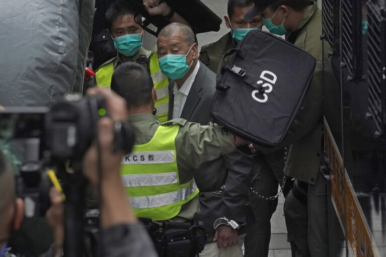 FILE - Jimmy Lai, center, arrives at Hong Kong's Court of Final Appeal in Hong Kong, on Feb. 9, 2021. In exclusive photos taken by The Associated Press, Lai looks thinner than when he was last photographed in February 2021. (AP Photo/Kin Cheung, File)
