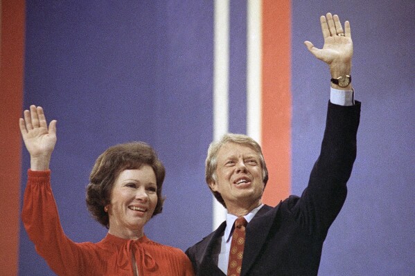 FILE - Jimmy Carter, right, and his wife, Rosalynn Carter, wave together at the National Convention in Madison Square Garden, July 15, 1976, in New York. Rosalynn Carter, the closest adviser to Jimmy Carter during his one term as U.S. president and their four decades thereafter as global humanitarians, died Sunday, Nov. 19, 2023. She was 96. (AP Photo, File)
