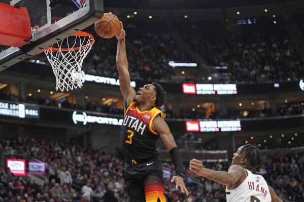 Utah Jazz guard Trent Forrest (3) dunks as Denver Nuggets guard Bones Hyland watches during the second half of an NBA basketball game Wednesday, Feb. 2, 2022, in Salt Lake City. (AP Photo/Rick Bowmer)