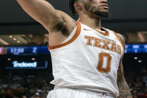 Texas forward Timmy Allen salutes the crowd after making a basket during the first half the team's NCAA college basketball game against UTEP, Monday, Nov. 7, 2022, in Austin, Texas. (AP Photo/Michael Thomas)