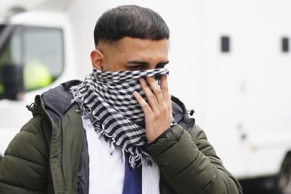 West Yorkshire Police officer Mohammed Adil, 26, leaves Westminster Magistrates' Court in central London, Thursday May 2, 2024, after he admitted two counts of publishing an image in support of Hamas, which is banned and designated a terror group in the U.K., the Independent Office for Police Conduct said. (Victoria Jones/PA via AP)