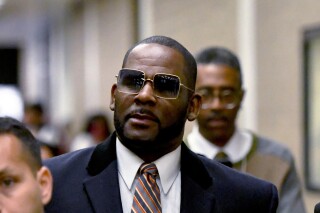 FILE - R. Kelly leaves the Daley Center after a hearing in his child support case, May 8, 2019, in Chicago. R. Kelly’s lawyer told an appeals court Monday, March 18, 2024, that all kinds of legitimate organizations — even college fraternities — could be deemed racketeering organizations under a law unjustly used to convict the R&B superstar at his Brooklyn trial of sexually abusing young fans, including some who were children, for decades. (AP Photo/Matt Marton, File)