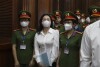 Vietnamese real estate tycoon Truong My Lan, front center, is escorted into a courtroom in Ho Chi Minh city, Vietnam, Tuesday, March 5, 2024. Lan faces the death penalty in a trial that began Tuesday over alleged fraud amounting to $12.5 billion, nearly 3% of the country’s 2022 GDP. (Phan Thanh Vu/VNA via AP)