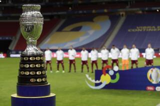 The Copa America trophy is placed on the field prior to the opening match between Brazil and Venezuela at National Stadium in Brasilia, Brazil, Sunday, June 13, 2021. (AP Photo/Eraldo Peres)