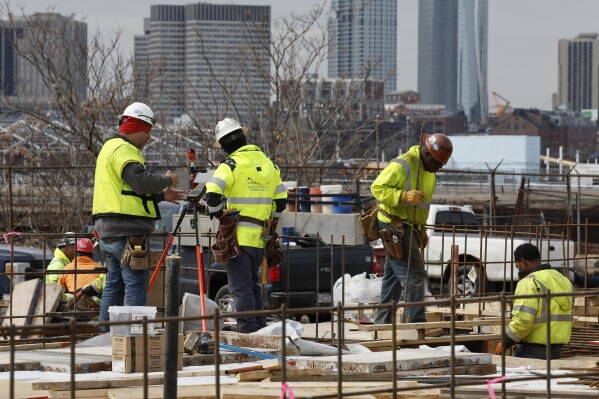 File - Construction workers prepare a recently poured concrete foundation, Friday, March 17, 2023, in Boston. On Thursday, the Labor Department reports on job openings and labor turnover for May. (AP Photo/Michael Dwyer, File)