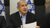 Israeli Prime Minister Benjamin Netanyahu, centre, speaks during the weekly cabinet meeting at the Defence Ministry in Tel Aviv, Israel, Sunday Jan. 7, 2024. (Ronen Zvulun/Pool via AP)