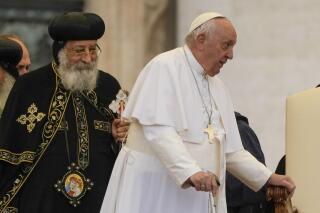 Pope Francis, right, arrives for his weekly general audience in St. Peter's Square at The Vatican, with the leader of the Coptic Orthodox Church of Alexandria, Tawadros II,Wednesday, May 10, 2023. (AP Photo/Alessandra Tarantino)