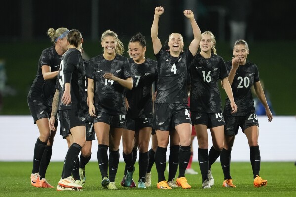 New Zealand's CJ Bott, third right, reacts after scoring her team's first goal during the New Zealand and Vietnam warm up match ahead of the women's World Cup in Napier, New Zealand, Monday, July 10, 2023. (AP Photo/John Cowpland )