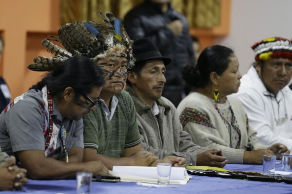 Indigenous leaders attend negotiations with President Lenin Moreno in Quito, Ecuador, Sunday, Oct. 13, 2019. The government and indigenous protesters started negotiations aimed at defusing more than a week of demonstrations that have paralyzed the nation's economy. (AP Photo/Fernando Vergara)