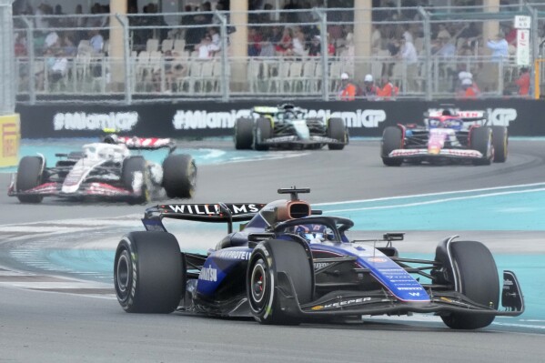 Williams driver Alexander Albon, foreground, of Thailand, steers into a turn followed by Haas driver Nico Hulkenberg, of Germany, RB driver Daniel Ricciardo, of Australia, and Aston Martin driver Lance Stroll, of Canada, during the Formula One Miami Grand Prix auto race Sunday, May 5, 2024, in Miami Gardens, Fla. (AP Photo/Wilfredo Lee)
