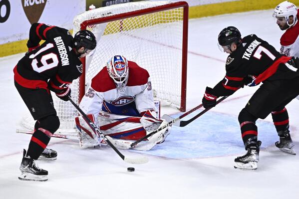 Ottawa Senators right wing Drake Batherson (19) and left wing Brady Tkachuk (7) try to get a shot on Montreal Canadiens goaltender Sam Montembeault (35) during the third period of an NHL hockey game in Ottawa, on Wednesday, Dec. 14, 2022. (Justin Tang/The Canadian Press via AP)