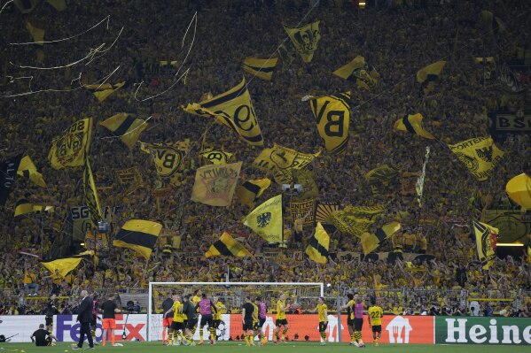 A Dortmund supporter waves a flag after the Champions League semi-final first leg soccer match between Borussia Dortmund and Paris Saint-Germain at Zinal Iduna Park Stadium in Dortmund, Germany, Wednesday, May 1, 2024 (AP Photo/ Matthias Schröder)