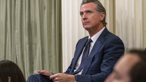 FILE – California Gov. Gavin Newsom sits in the state Assembly at the state Capitol, June 30, 2023, in Sacramento, Calif. In an interview with The Associated Press, Newsom said the prospect of multi-billion dollar budget deficits over the next few years does not change his agenda for his second term in office. Newsom said he will focus on implementing the programs he launched in his first term, including free kindergarten for all 4-year-olds and free health care for low-income residents regardless of their immigration status. (AP Photo/Rich Pedroncelli,File)