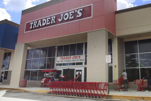 FILE - People stand in line waiting to enter Trader Joe's to buy groceries in Pembroke Pines, Fla., on March 24, 2020. A Trader Joe’s store in Louisville, Kentucky, has voted to unionize. Workers at the store voted 48-36 in favor of the union on Thursday evening, Jan. 26, 2023, according to the National Labor Relations Board, which conducted the election. (AP Photo/Brynn Anderson, File)