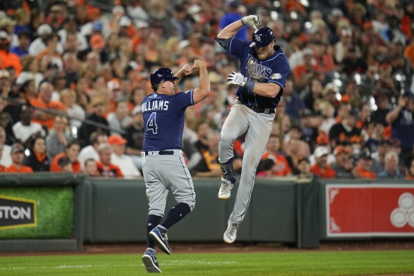 Tampa Bay Rays' Luke Raley, right, celebrates with third base coach Brady Williams (4) while running the bases after hitting a solo home run against the Baltimore Orioles in the seventh inning of a baseball game, Thursday, Sept. 14, 2023, in Baltimore. The Rays won 4-3. (AP Photo/Julio Cortez)