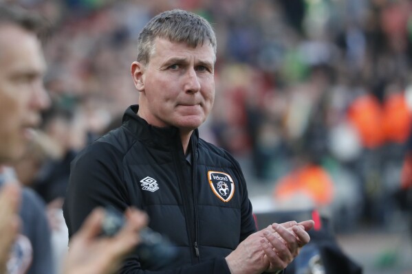 FILE - Republic of Ireland coach Stephen Kenny claps prior to the start of their international friendly soccer match against Belgium at the Aviva Stadium in Dublin, Ireland, Saturday, March 26, 2022. Kenny’s contract as coach of Ireland won’t be renewed after the team failed to qualify for the European Championship. The Football Association of Ireland announced its decision Wednesday, Nov. 22, 2023 following the completion of the Euro 2024 qualifying campaign. (AP Photo/Peter Morrison, file)