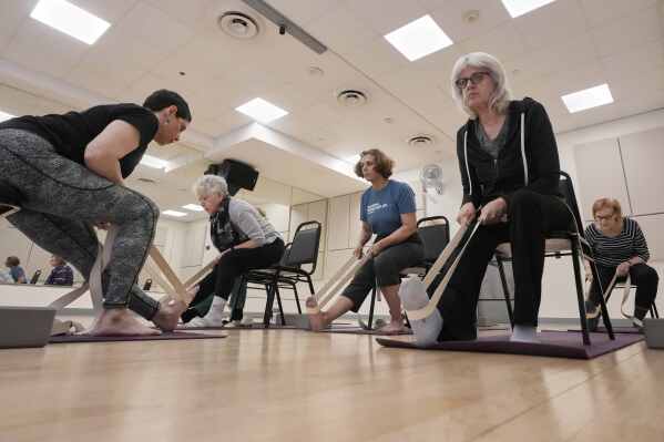 Whitney Chapman, left, conducts a chair yoga class at the Marlene Meyerson JCC Manhattan, in New York, March 28, 2025. (AP Photo/Richard Drew)