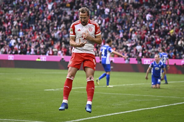 Bayern's Harry Kane celebrates after scoring during the German Bundesliga soccer match between Bayern Munich and SV Darmstadt 98 at the Allianz Arena in Munich, Germany, Saturday, Oct. 28, 2023. (Tom Weller/dpa via AP)