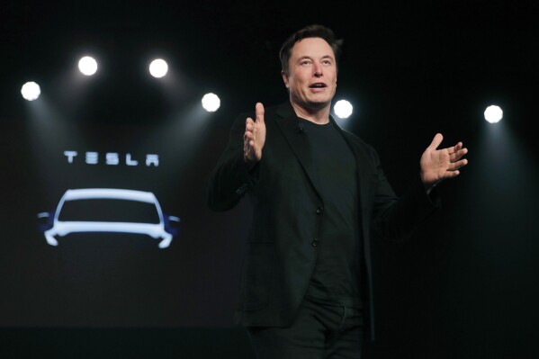 FILE- Tesla CEO Elon Musk speaks before unveiling the Model Y at Tesla's design studio March 14, 2019, in Hawthorne, Calif. A Florida judge ruled Friday, Nov. 17, 2023, that a jury should decide whether Tesla and Elon Musk oversold the electric car company's Autopilot system that caused the fatal crash of a software engineer who engaged it and took his hands off the steering wheel. A trial is scheduled for 2024. (AP Photo/Jae C. Hong, File)