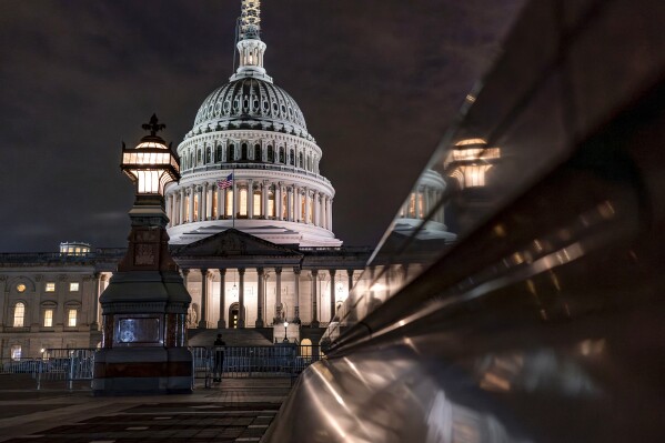 The Capitol is seen late Tuesday night, Sept. 26, 2023, in Washington, as lawmakers work to advance appropriations bills on the House floor. The Republican-controlled House and the Democrat-controlled Senate are starkly divided over very different paths to preventing a federal shutdown. (AP Photo/J. Scott Applewhite)