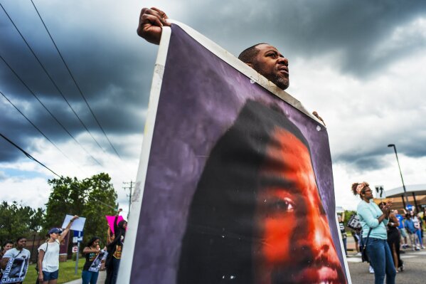 
              John Thompson, who said he was a close friend of Philando Castile, protests during a demonstration, Sunday, June 18, 2017, in St. Anthony, Minn. The protesters marched against the acquittal of Officer Jeronimo Yanez, was found not guilty of manslaughter for shooting Castile during a traffic stop. (Richard Tsong-Taatarii/Star Tribune via AP)
            