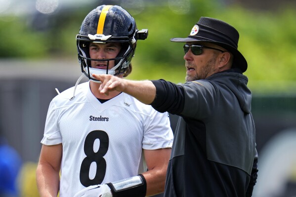 Pittsburgh Steelers quarterback Kenny Pickett, left, listens to offensive coordinator Matt Canada during the first day of the NFL football team's minicamp, in Pittsburgh on Tuesday, June 13, 2023. (AP Photo/Gene J. Puskar)