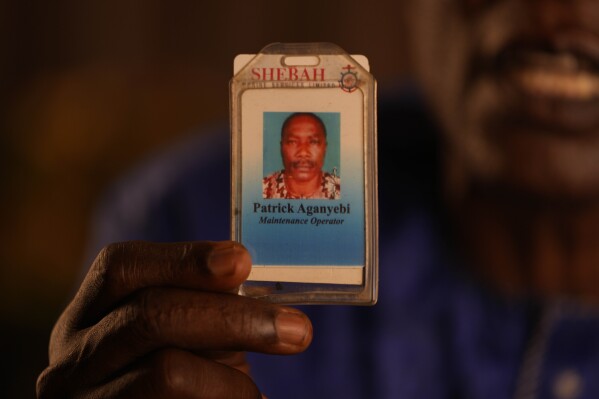 Patrick Aganyebi, operador de mantenimiento a bordo del buque petrolero Trinity Spirit, sostiene su tarjeta de identificación en su casa en Igbokoda, Nigeria, el martes 6 de septiembre de 2022. Días después de ser hospitalizado por las heridas que sufrieron al escapar del incendio en el Trinity. Spirit, Aganyebi y su colega Pius Orofin se enteraron de que iban a ser enviados a prisión, acusados ​​de conspirar para cometer “asesinato, incendio provocado y daños maliciosos”, según los documentos de la acusación.  (Foto AP/Sunday Alamba)