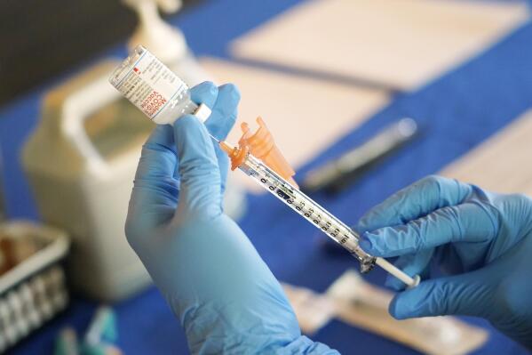 FILE - A nurse prepares a syringe of a COVID-19 vaccine at an inoculation station in Jackson, Miss., Tuesday, July 19, 2022. On Friday, Dec. 30, The Associated Press reported on stories circulating online incorrectly claiming the COVID-19 vaccines “are a gene therapy." (AP Photo/Rogelio V. Solis, File)