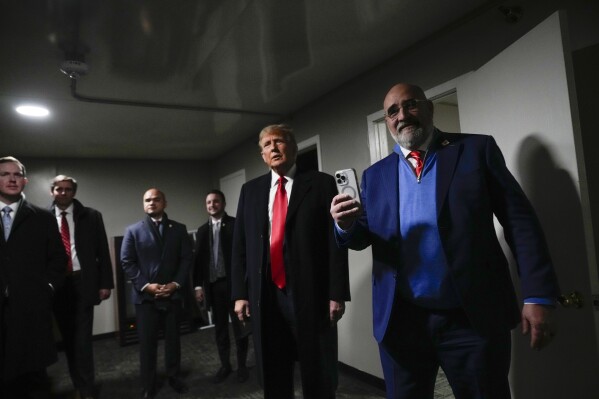 Republican presidential candidate former President Donald Trump stands in a back stage area after speaking at a caucus site at Horizon Events Center, in Clive, Iowa, Monday, Jan. 15, 2024. (AP Photo/Andrew Harnik)