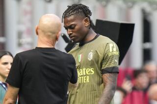 AC Milan's Rafael Leao leaves the pitch after an injury during a Serie A soccer match between AC Milan and Lazio, at the San Siro stadium in Milan, Italy, Saturday, May 6, 2023. (AP Photo/Luca Bruno)