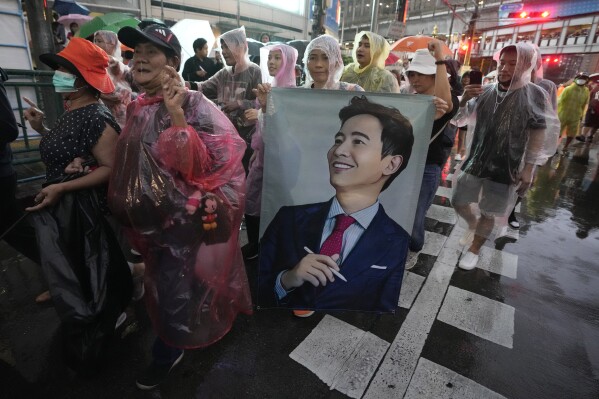 FILE - Supporters of the Move Forward Party hold a portrait of Pita Limjaroenrat, the leader of Move Forward Party, during a protest in Bangkok, Thailand, July 23, 2023. An expected fresh try by Thailand’s Parliament to select a new prime minister on Thursday, July 25, has been postponed, adding to a growing sense of uncertainty over when a new government can take office, more than two months after the country’s general election.(AP Photo/Sakchai Lalit)
