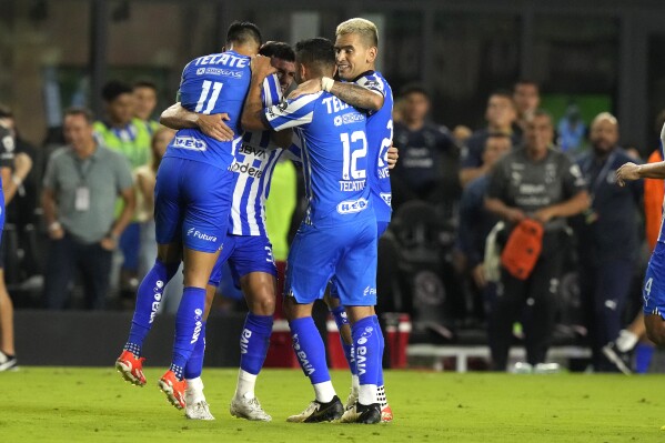 Monterrey midfielder Jorge Rodríguez, second from left, celebrates with midfielder Maximiliano Meza (11), forward Jesús Manuel Corona (12) and another teammate after scoring a goal against Inter Miami during the second half of a CONCACAF Champions Cup quarterfinal soccer match, Wednesday, April 3, 2024, in Fort Lauderdale, Fla. (AP Photo/Lynne Sladky)