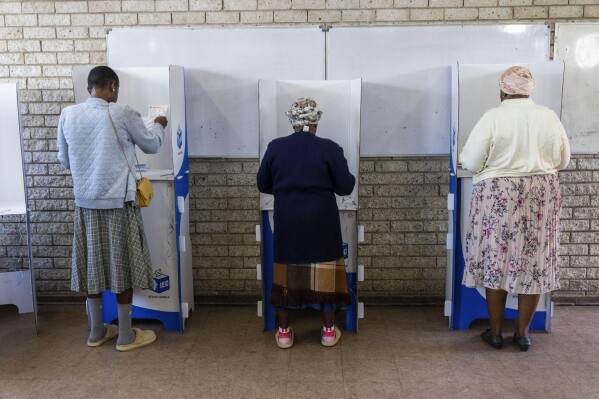Voters prepare to cast their ballot Wednesday, May 29, 2024 during general elections in Soweto, South Africa. South Africans are voting in an election seen as their country's most important in 30 years, and one that could put them in unknown territory in the short history of their democracy, the three-decade dominance of the African National Congress party being the target of a new generation of discontent in a country of 62 million people — half of whom are estimated to be living in poverty. (AP Photo/Jerome Delay)