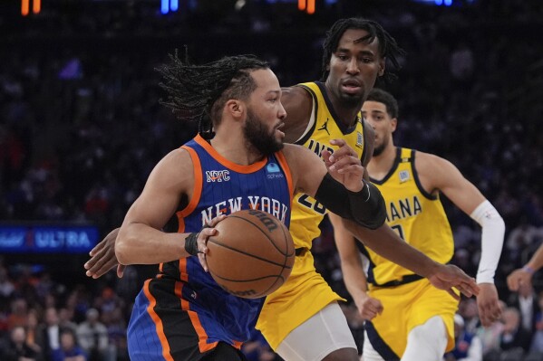 New York Knicks' Jalen Brunson, left, drives past Indiana Pacers' Aaron Nesmith during the second half of Game 5 in an NBA basketball second-round playoff series, Tuesday, May 14, 2024, in New York. The Knicks won 121-91. (AP Photo/Frank Franklin II)