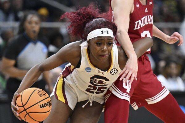 South Carolina guard Raven Johnson (25) drives around Indiana guard Yarden Garzon (12) during the first half of a Sweet Sixteen round college basketball game during the NCAA Tournament, Friday, March 29, 2024, in Albany, N.Y. (AP Photo/Hans Pennink)