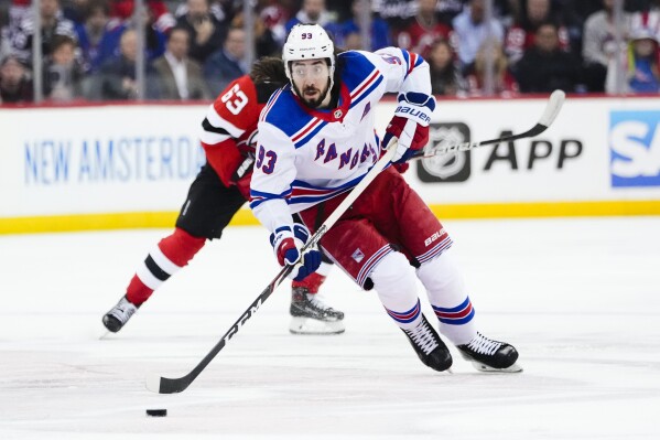 FILE - New York Rangers' Mika Zibanejad (93) looks to pass the puck during the first period of Game 5 of the team's NHL hockey Stanley Cup first-round playoff series against the New Jersey Devils, Thursday, April 27, 2023, in Newark, N.J. The Rangers season opens Oct. 12 at Buffalo. (AP Photo/Frank Franklin II, File)