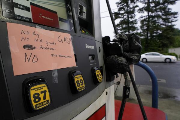 A hand written sign is posted on a gas pump, showing that the service station is out of all grades of fuel Wednesday, May 12, 2021, in Charlotte, N.C.  Several gas stations in the Southeast reported running out of fuel, primarily because of what analysts say is unwarranted panic-buying among drivers, as the shutdown of a major pipeline by hackers entered its fifth day.  (AP Photo/Chris Carlson)