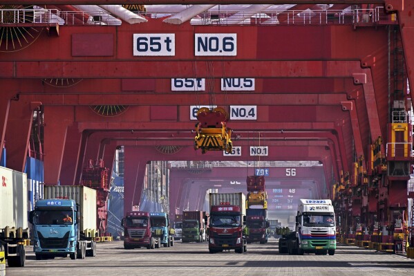 FILE - In this photo released by Xinhua News Agency, containers are unloaded from a cargo ship at Qingdao Port, east China's Shandong Province on Feb. 11, 2024. China's exports and imports returned to growth in April, suggesting that demand is improving despite an uneven economic recovery, according to customs data released Thursday, May 9, 2024. (Li Ziheng/Xinhua via AP, File)