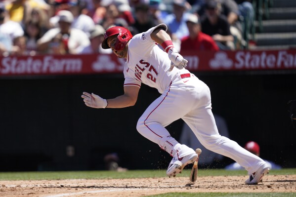 Los Angeles Angels designated hitter Mike Trout runs after grounding out to Minnesota Twins third baseman Jose Miranda who threw to first baseman Carlos Santana during the fourth inning of a baseball game, Sunday, April 28, 2024, in Anaheim, Calif. (AP Photo/Ryan Sun)
