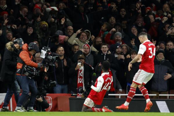 Arsenal's Eddie Nketiah, center, celebrates after scoring his side's third goal during the English Premier League soccer match between Arsenal and West Ham United at Emirates stadium in London, Monday, Dec. 26, 2022. (AP Photo/David Cliff)