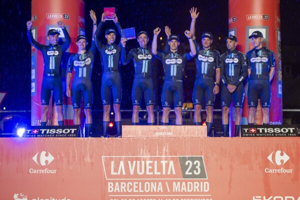 The Dutch DSM-Firmenich team cyclists celebrate on the podium after winning the time-trial on the first stage of La Vuelta cycling race in Barcelona, Spain, Aug. 26, 2023. DSM-Firmenich's Lorenzo Milesi of Italy is now leader after the first stage. (Lorena Sopena/Europa Press via AP)