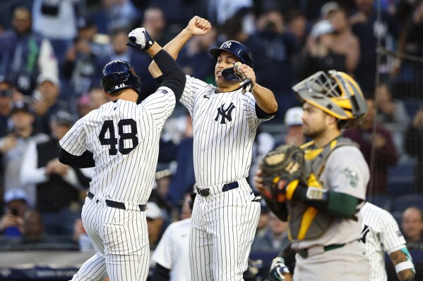 New York Yankees Anthony Rizzo, left, celebrates with Giancarlo Stanton, right, after hitting a home run against the Oakland Athletics during the first inning of a baseball game, Tuesday, April 23, 2024 in New York. (AP Photo/Noah K. Murray)